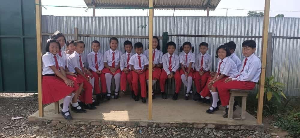School students in uniform seated together after class