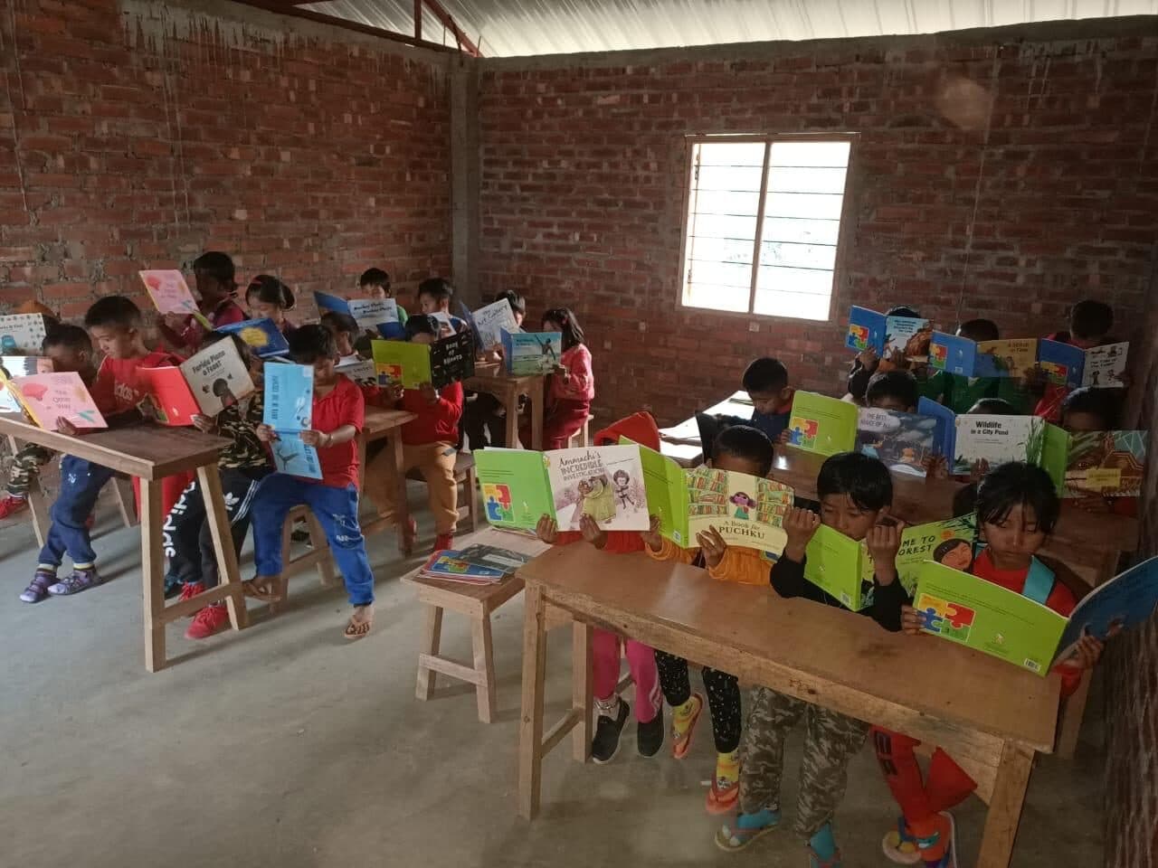 Young readers absorbed in picture books at the reading room