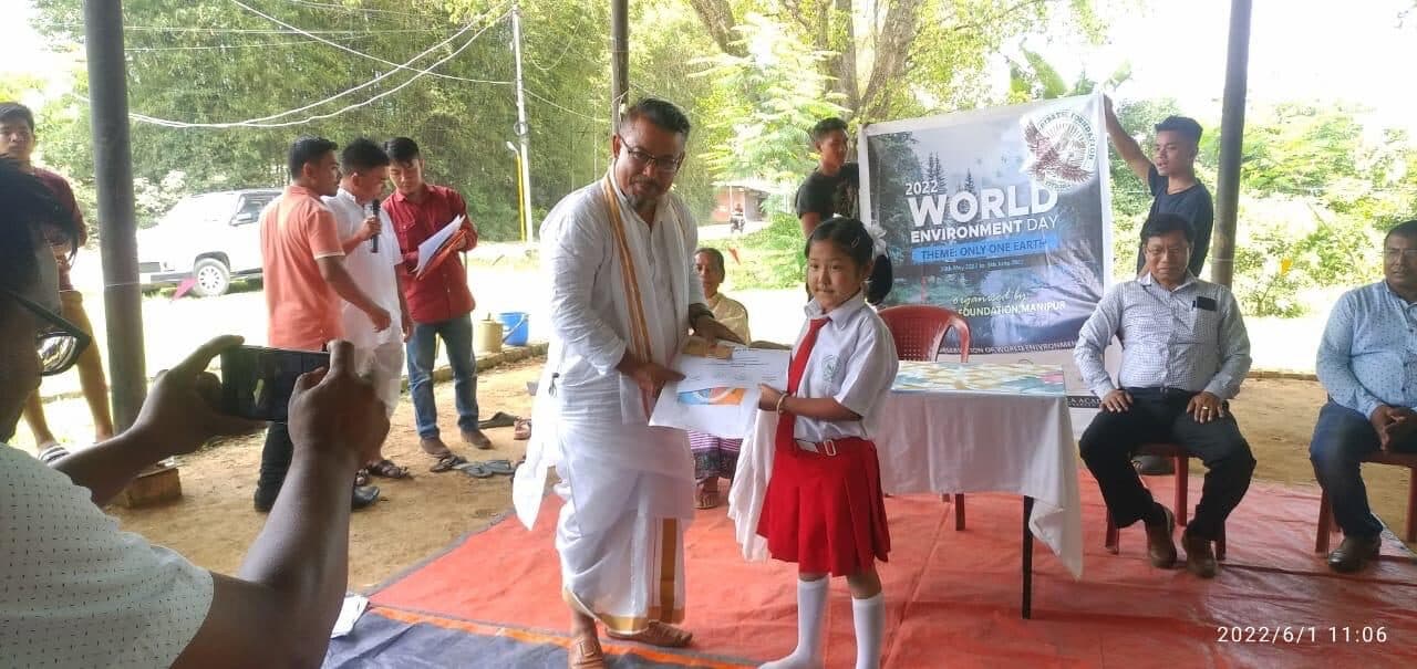 A young participant receiving a prize on World Environment Day