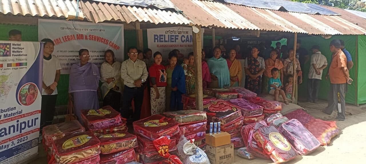 Sacks of rice and essentials stacked for distribution at a relief camp