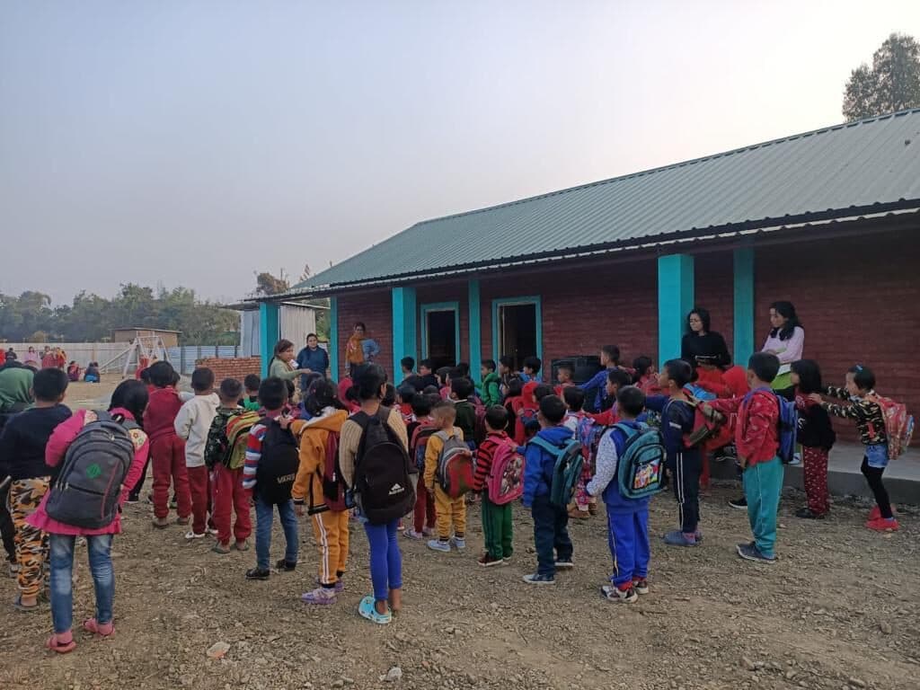 Students with schoolbags gathered in the courtyard before morning assembly